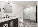 Modern bathroom with marble vanity and glass shower at 8823 Dartmoor Pl, Mint Hill, NC 28227