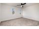 Bright bedroom with neutral walls and carpeted floor at 8823 Dartmoor Pl, Mint Hill, NC 28227