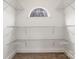 Spacious walk-in closet with wire shelving and arched window at 8823 Dartmoor Pl, Mint Hill, NC 28227