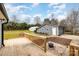 Wooden deck overlooking backyard with fire pit and detached garage at 8823 Dartmoor Pl, Mint Hill, NC 28227