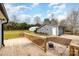 Wooden deck overlooking backyard with fire pit and detached garage at 8823 Dartmoor Pl, Mint Hill, NC 28227