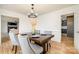 Bright dining room with chandelier and view into living room and kitchen at 8823 Dartmoor Pl, Mint Hill, NC 28227