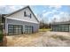 Two-car garage with modern glass garage doors and additional shed at 8823 Dartmoor Pl, Mint Hill, NC 28227