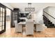 Modern kitchen with black cabinets, white island, and breakfast nook at 8823 Dartmoor Pl, Mint Hill, NC 28227