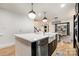 Modern kitchen island with quartz countertop and farmhouse sink at 8823 Dartmoor Pl, Mint Hill, NC 28227