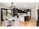 Stylish kitchen boasts black cabinets, quartz countertops, and a large island at 8823 Dartmoor Pl, Mint Hill, NC 28227