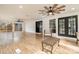 Bright sunroom with hardwood floors, ceiling fan, and access to backyard at 8823 Dartmoor Pl, Mint Hill, NC 28227