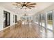 Relaxing sunroom featuring hardwood floors, a ceiling fan and access to a deck at 8823 Dartmoor Pl, Mint Hill, NC 28227