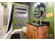 Bathroom with green walls, floral wallpaper, wood vanity, and gold fixtures at 1115 Stony Point Rd, Kings Mountain, NC 28086