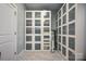 Large walk-in closet with mirrored doors, custom shelving, and ample space for storage at 1115 Stony Point Rd, Kings Mountain, NC 28086