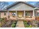 The inviting front porch offers a comfortable seating area and a bright yellow door at 1115 Stony Point Rd, Kings Mountain, NC 28086