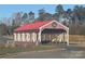 Community entrance with charming covered bridge at 11808 Glenwood Dr, Locust, NC 28097