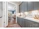 Stylish butler's pantry with gray cabinets, white countertops, and a chevron backsplash at 14104 Hollins Grove Ave, Huntersville, NC 28078