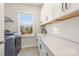 Laundry room with white cabinets, countertop, and washer and dryer at 14104 Hollins Grove Ave, Huntersville, NC 28078