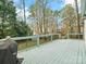 Large, fenced backyard with a deck, storage shed, and mature trees, perfect for entertaining at 151 Paseo Dr, Mooresville, NC 28117