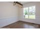 Bright dining room features hardwood floors, wainscoting, and a stylish light fixture at 2011 Cedar Falls Dr # 71, Waxhaw, NC 28173