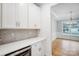 White kitchen with built-in wine cooler and quartz countertops at 2011 Cedar Falls Dr # 71, Waxhaw, NC 28173