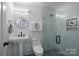 Clean bathroom with pedestal sink, glass shower, and geometric tile at 2019 Thurmond Pl # 13, Charlotte, NC 28205