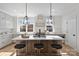 Modern kitchen with island, white cabinets, and stainless steel appliances at 2019 Thurmond Pl # 13, Charlotte, NC 28205
