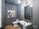 Elegant powder room with a pedestal sink and dark-painted walls at 2023 Thurmond Pl # 14, Charlotte, NC 28205