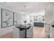 Open concept dining room with modern light fixture and gray chairs at 2023 Thurmond Pl # 14, Charlotte, NC 28205