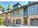 Brick and gray townhouses with dark garage doors and dormers at 2023 Thurmond Pl # 14, Charlotte, NC 28205