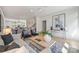 Light and airy living room with neutral furniture and large art at 2023 Thurmond Pl # 14, Charlotte, NC 28205