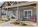 Inviting front porch with seating and decorative plants at 212 Tournament Sw Dr, Concord, NC 28025