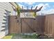 Wooden gate with pergola providing access to the backyard at 212 Tournament Sw Dr, Concord, NC 28025