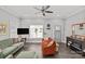 Living Room with orange couch, green couch, and a ceiling fan at 212 Tournament Sw Dr, Concord, NC 28025