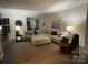 Spacious living room featuring plush seating, modern decor, and ample natural light at 2133 Tupelo Grove Ln, Gastonia, NC 28054