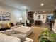 Open-concept living room with comfortable sectional sofa and view of the kitchen and dining area at 2133 Tupelo Grove Ln, Gastonia, NC 28054