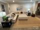 Inviting living room with a large sectional sofa, rocking chair, and stylish decor at 2133 Tupelo Grove Ln, Gastonia, NC 28054