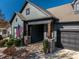 Gray house with stone pillars, two-car garage, and American flag at 2221 Lexington St, Belmont, NC 28012