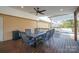 Covered deck with dining table and a view of the adjacent pergola-covered deck at 2654 Saddlewood Cir, Concord, NC 28027