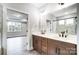 Bathroom with double vanity and a view of a bedroom at 3011 Whispering Creek Dr # 145, Indian Trail, NC 28079