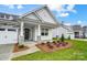 New construction home with stone accents and a welcoming front porch at 3011 Whispering Creek Dr # 145, Indian Trail, NC 28079