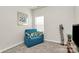 Bonus room featuring a blue loveseat, media storage, and carpeted floors at 3532 Tully Ave, Kannapolis, NC 28081