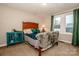 Cozy bedroom with a wooden bed frame and teal accents at 364 Scotts Creek Rd, Statesville, NC 28625