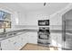 White cabinets, granite countertops, and stainless steel appliances in this kitchen at 5021 Prestwick Ln, Charlotte, NC 28212