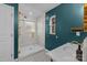 Updated bathroom with teal walls and a walk-in shower at 5501 Chedworth Dr, Charlotte, NC 28210