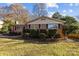 Brick ranch house with well-manicured lawn and shrubs at 5501 Chedworth Dr, Charlotte, NC 28210