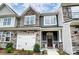 Two-story townhome with stone facade and two-car garage at 6256 Culbert St # 187, Harrisburg, NC 28075