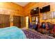 Bedroom with wood walls, teal bedding, and large TV at 633 Weston Acres Rd, Fort Lawn, SC 29714