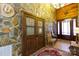 Inviting entryway with stone accent wall, wood doors, and a charming rug at 633 Weston Acres Rd, Fort Lawn, SC 29714