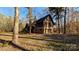 Log cabin home with stone accents and a two-car garage at 633 Weston Acres Rd, Fort Lawn, SC 29714