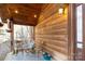 Relaxing front porch with rocking chairs, wooden walls, and hanging plants at 633 Weston Acres Rd, Fort Lawn, SC 29714