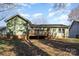 Green house exterior with deck and backyard at 7208 Rockwood Forest Ln, Charlotte, NC 28212