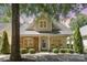 Charming two-story home with stone and siding exterior, front porch, and landscaped yard at 7930 Tigers Paw Rd, Huntersville, NC 28078