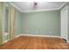 Spacious bedroom with hardwood floors and light green walls at 805 Prince Albert Ct, Statesville, NC 28677